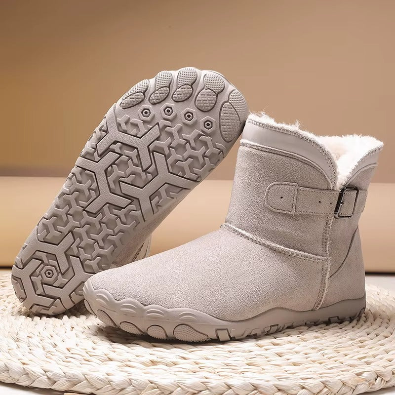 Gevoerde laarzen in lichtgrijs met zicht op de antislip barefoot-zool